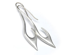 A pair of silver earrings with unique, curved shapes.