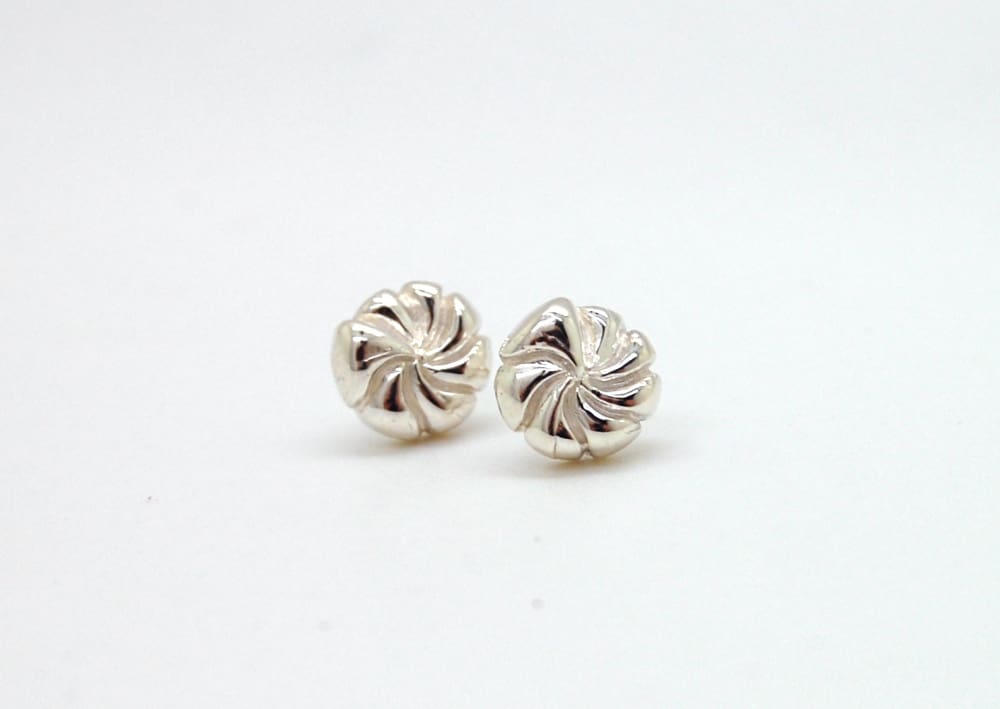 Two silver earrings with spiral designs are shown against a white background.