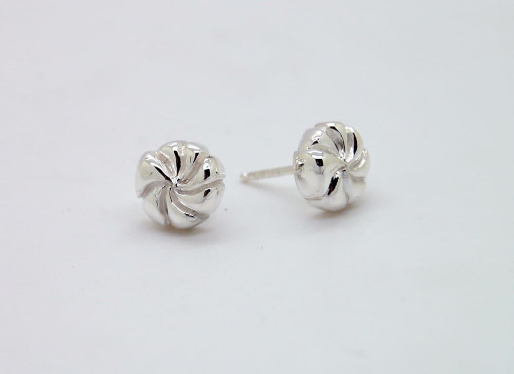 A pair of silver earrings with a twisted, spiral design on a white background.