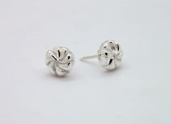 A pair of silver earrings with a twisted, spiral design on a white background.